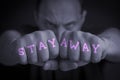 STAY AWAY written on an angry manâs fists Royalty Free Stock Photo